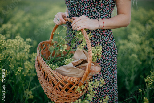 Wallpaper Mural Picnic basket with bread against the backdrop of a rapeseed field. Torontodigital.ca