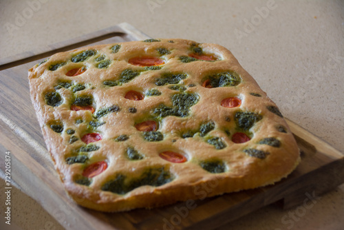 Home made focaccia with cherry tomatoes and basilica   