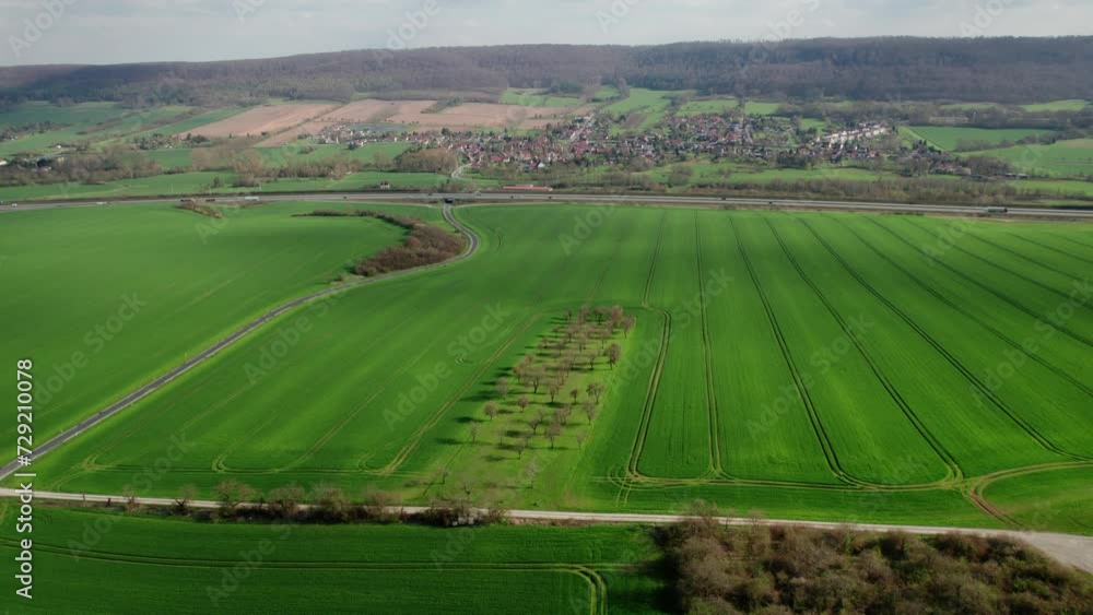 Drone flying over the agricultural field in the small town of Germany Drone flying over the agricultural field in the small town of Germany