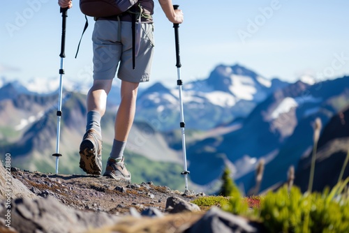 solo hiker with trekking poles on mountaintop