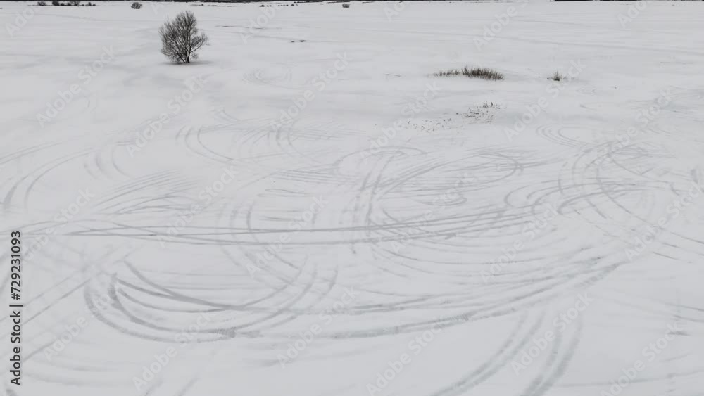 Snow drifts from above, drone perspective on wintry tracks Snow drifts from above, drone perspective on wintry tracks