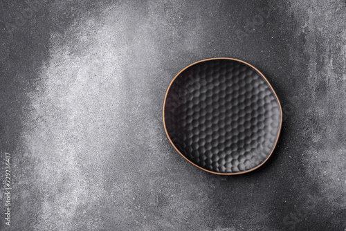 Empty round ceramic plate on a light texture background © chernikovatv