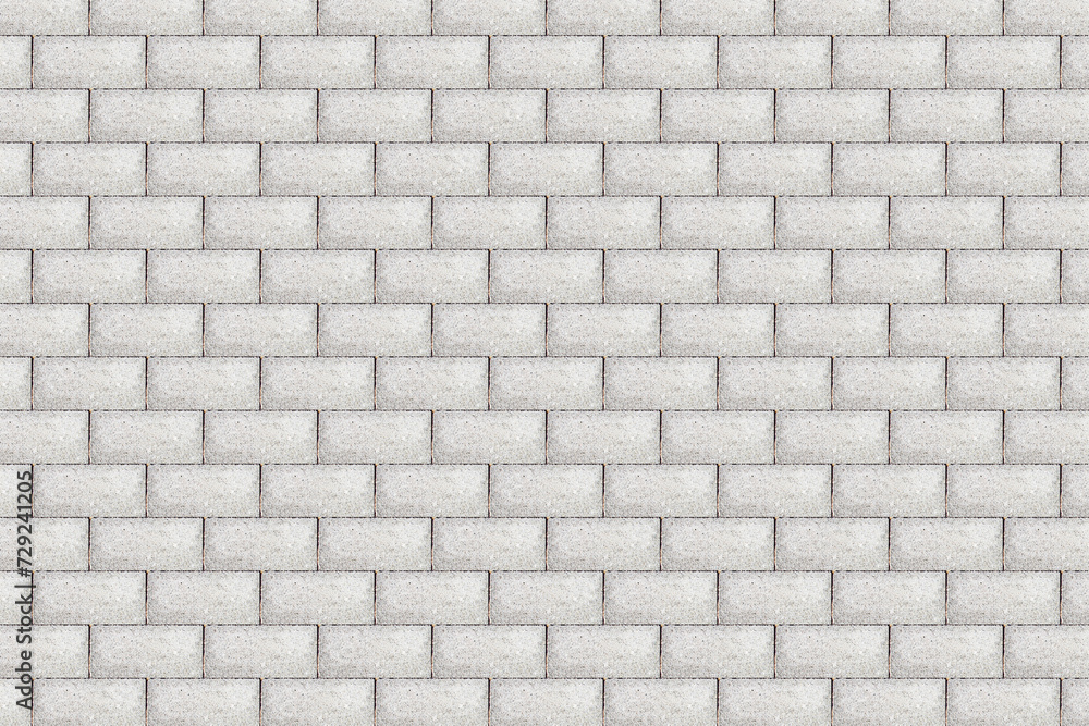 Gray brick pavement texture. Even blocks pattern. Brick flooring. Outdoor sunny texture. Walkway background. Brick pattern. Closeup construction. Rectangle blocks.