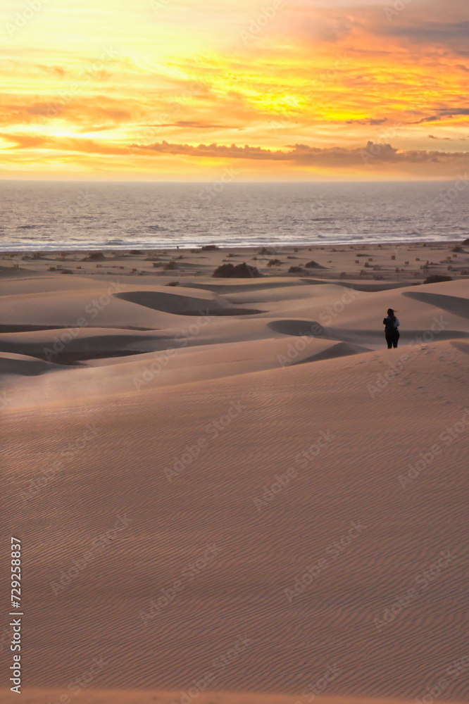 Girl looking sunrise in Maspalomas. Spanish sunrise in Spain. Gran Canaria Sunrise and sunsets. Girl looking sunrise in Maspalomas. Spanish sunrise in Spain. Gran Canaria Sunrise and sunsets.