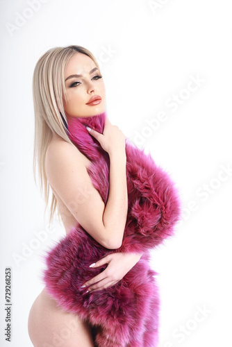 glamorous photo of a girl in lingerie and a bright purple fur coat made of natural fur. background white