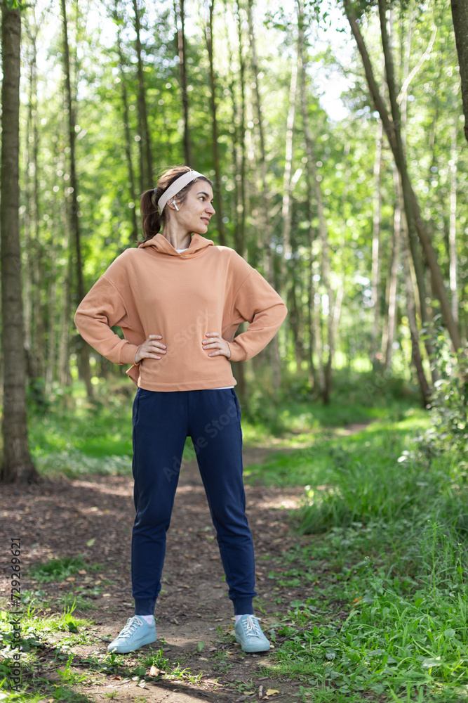 Woman with headphones exercising outdoor in the park. Sport activity lifestyle Woman with headphones exercising outdoor in the park. Sport activity lifestyle