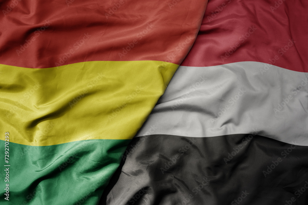 big waving national colorful flag of yemen and national flag of bolivia . big waving national colorful flag of yemen and national flag of bolivia .