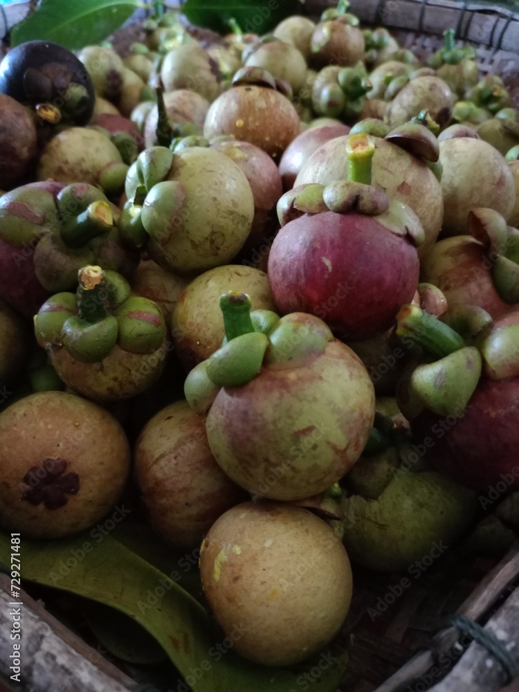 Mangosteen, a sweet, purple fruit from a Thai garden. Mangosteen, a sweet, purple fruit from a Thai garden.