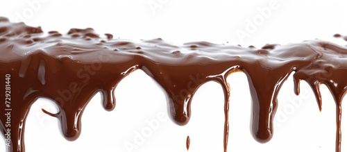 Hot chocolate syrup, now melted, drips in isolated streams on white background with a clipping path.