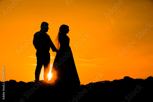 silhouettes Man and woman against the backdrop of sunset, lovers, intimacy