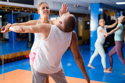 Young lady doing heel palm chin strike during group self-defence training.