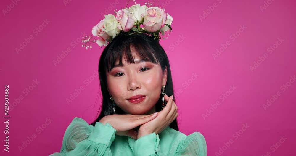 Flower crown, beauty and face of Asian woman in studio for wellness, organic products and skincare. Salon, floral aesthetic and portrait of person with cosmetics, makeup and touch on pink background Flower crown, beauty and face of Asian woman in studio for wellness, organic products and skincare. Salon, floral aesthetic and portrait of person with cosmetics, makeup and touch on pink background