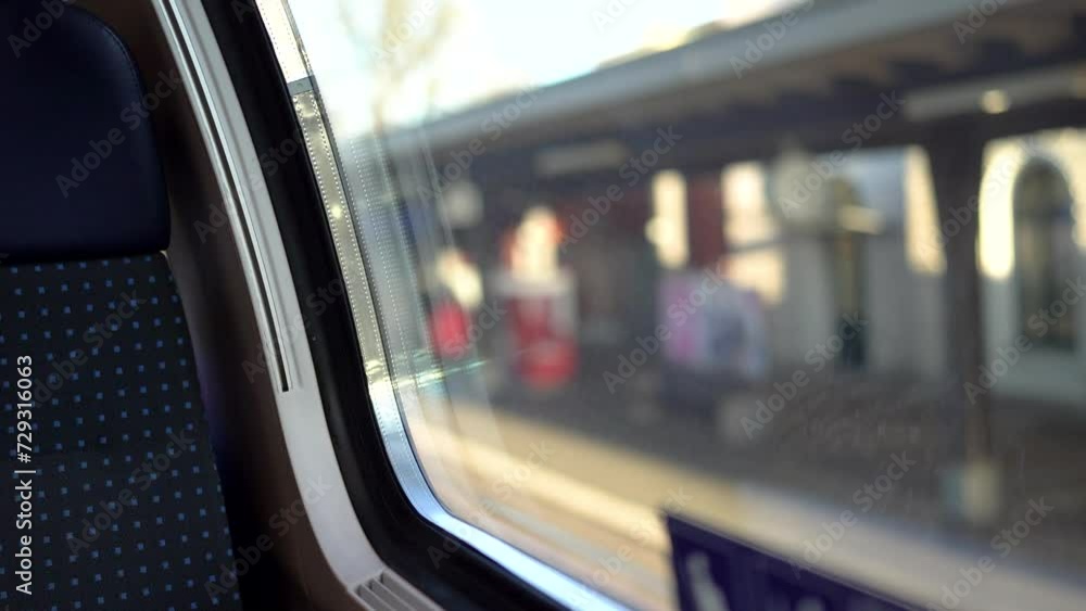 First person view from train window on train entering blurry station First person view from train window on train entering blurry station