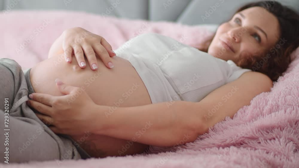 Happy pregnant woman expecting twins. Pregnant woman feeling happy at home while taking care of her child. Woman pregnancy concept and maternity prenatal care. Young expecting mother Slow motion. Happy pregnant woman expecting twins. Pregnant woman feeling happy at home while taking care of her child. Woman pregnancy concept and maternity prenatal care. Young expecting mother Slow motion.