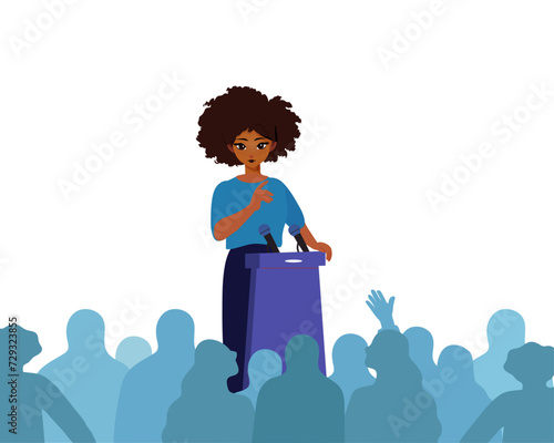 Female Public Speaker On Lectern In Front Of Audience.