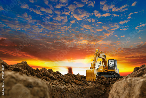 Crawler excavator with bucket lift up are digging the soil in the construction site on the sunset background