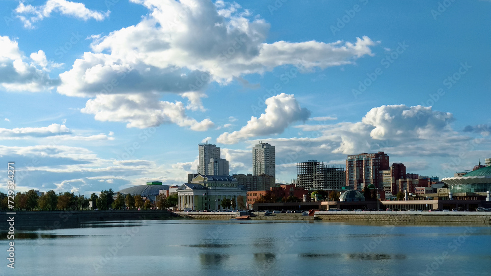 Buildings on the riverbank under a cloudy landscape Buildings on the riverbank under a cloudy landscape