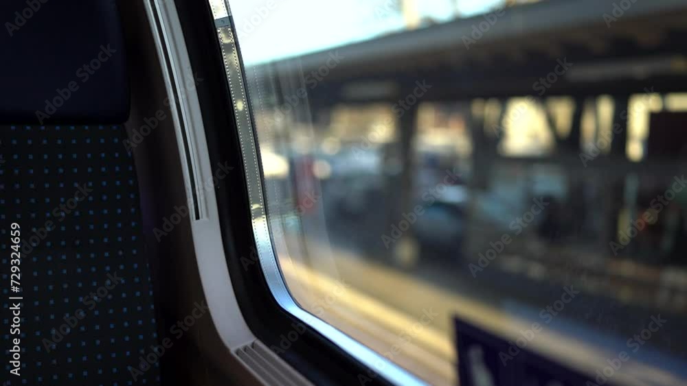 View from train window of departing train with blurry outside View from train window of departing train with blurry outside