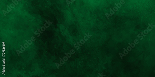 Abstract texture of emerald green color,Throwing green powder out of hand against black background.with space for texter,Dark cracked cement and smoked poster.