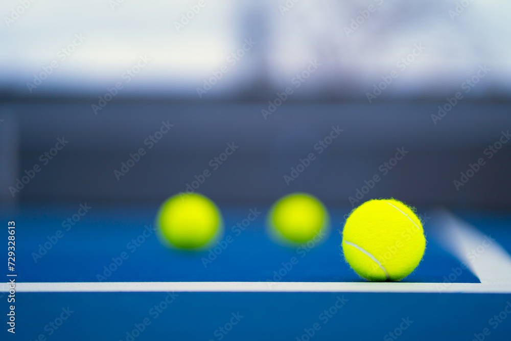 new tennis ball in blue hard court