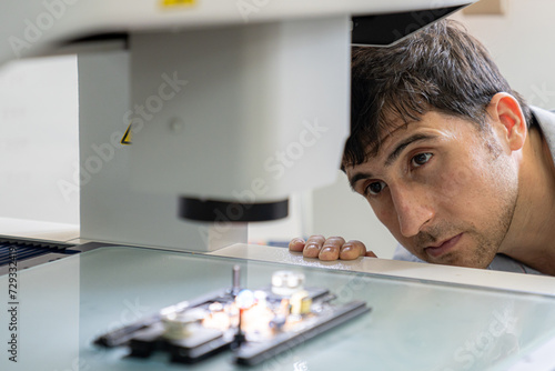 Technical Industrial Engineer Check electronic components. Quality control worker analyzing scientific experiments on a manufacturing machine.