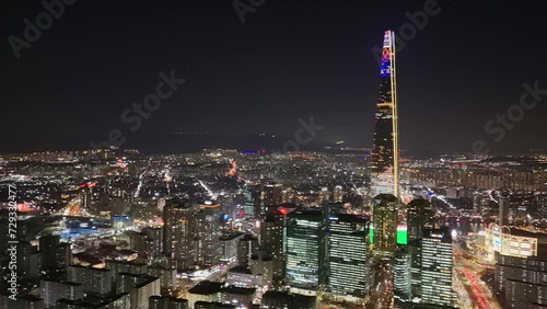 Night in Seoul illuminates Lotte World Tower symbol of Asian innovation Lotte World Tower majestic central to Seoul's pulsating life. Glow around Lotte World Tower Seoul's vibrant urban heart. photo