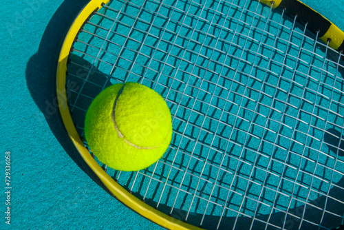 tennis racket and ball on a tennis court on a bright sunny day © Павел Мещеряков