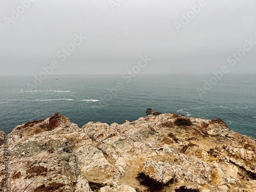 Rocky ocean coast, ocean bay, blue sky photo