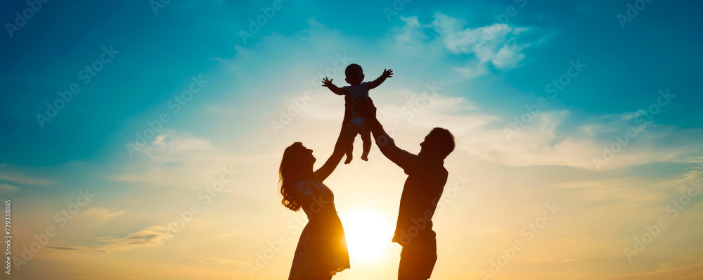 Dad and Mom raised a small child in their arms. Signs the family at sunset. People walk in nature. Side view. Dad and Mom raised a small child in their arms. Signs the family at sunset. People walk in nature. Side view.
