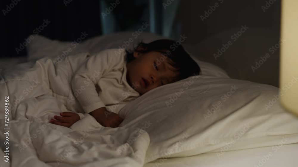 panning shot of toddler baby sleeping on a bed at night panning shot of toddler baby sleeping on a bed at night