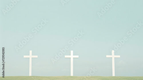 Three white crosses standing on a green hill under a soft sky, a powerful symbol of Christian faith and hope.