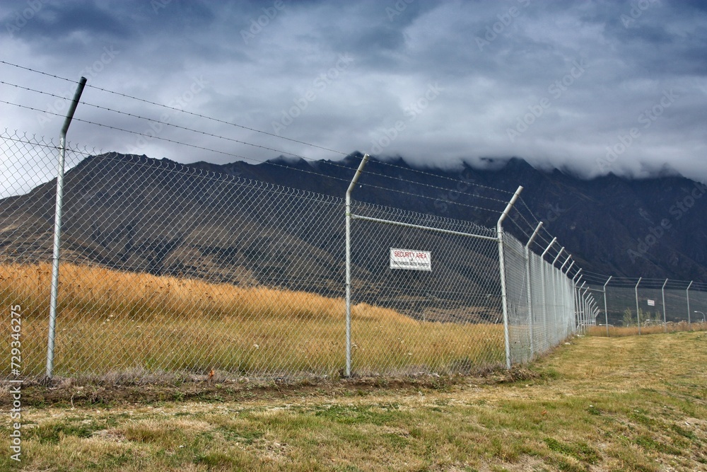 High fence with barbed wire