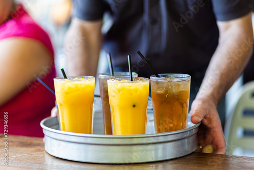 Drinks being served on tray at pub orange juice and ginger ale photo