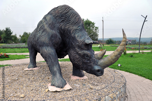 Pidhirya village, Ivano-Frankivsk region, Ukraine - September 26, 2023: Concrete sculpture of ancient wooly rhinoceros  in the Earth History Park. photo