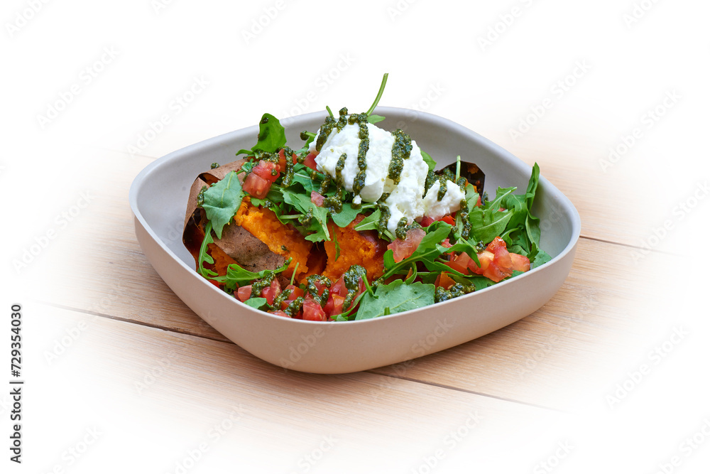 Bowl with hot patatoes, salad and pesto on white and wood Bowl with hot patatoes, salad and pesto on white and wood
