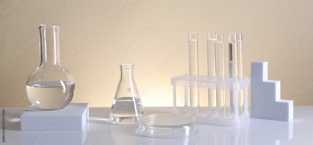 Laboratory analysis. Different glassware on table against beige background Laboratory analysis. Different glassware on table against beige background