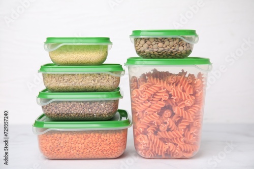 Plastic containers filled with food products on white table