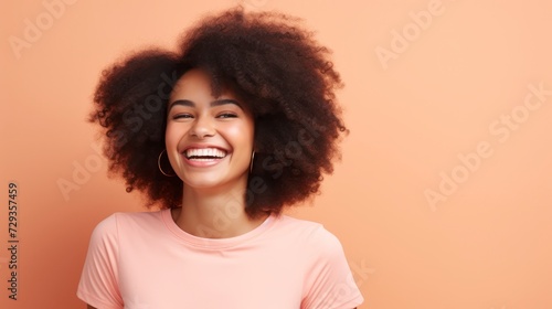 Young woman with afro hairstyle smiling at camera © Voilla