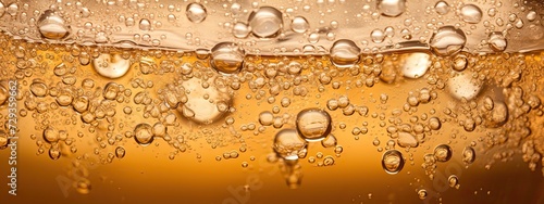 a glas of light light yellow brown soda, with alot of bubbles and smal fizzes and couple of ice cubes. Zoomed in so we see the top half of the glas, Perspective zoomed in on surface, from slighty abov