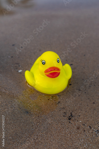 Big yellow rubber duck on the beach.