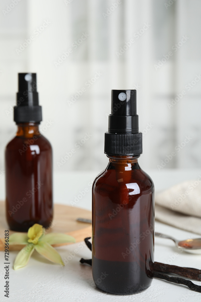 Aromatic homemade vanilla extract on white table Aromatic homemade vanilla extract on white table