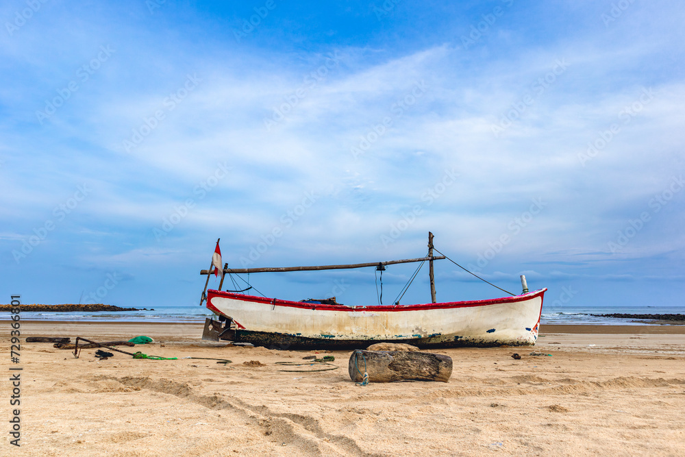 View of clear sky with traditional fishing boats on Sumenep beach, Madura island, Indonesia