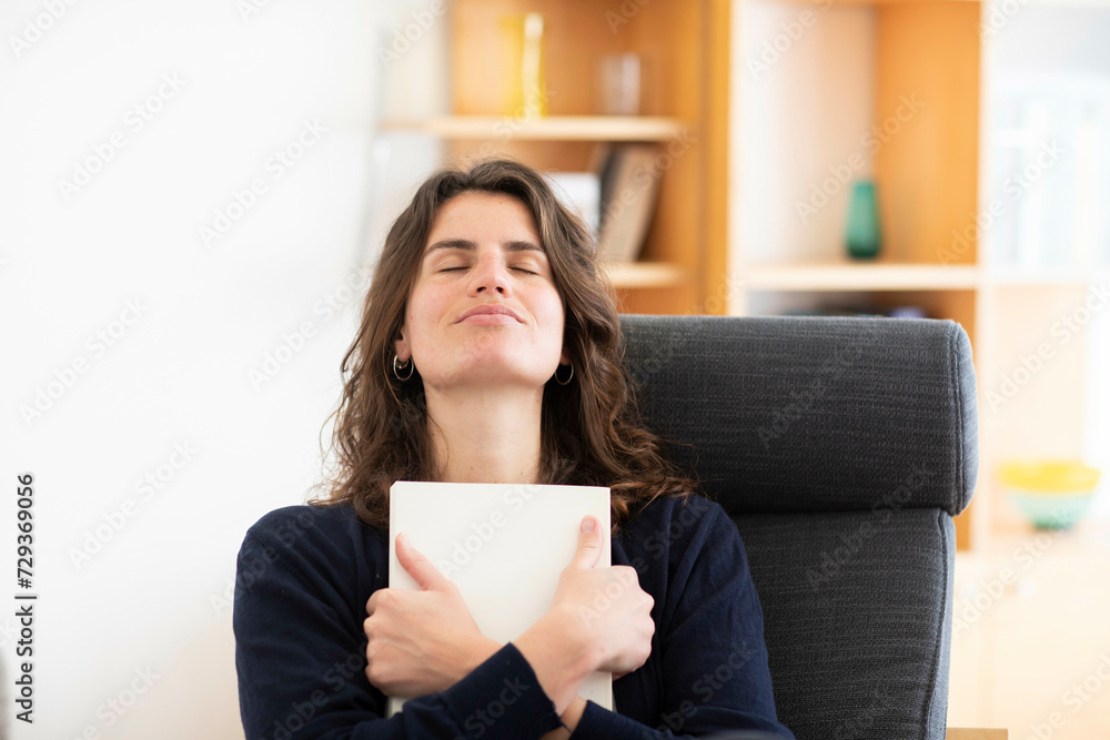 Young woman sitting at home, enjoying the moment Young woman sitting at home, enjoying the moment