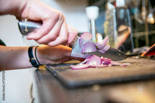Attractive single woman making lunch for herself. chopping vegetables for a healthy modern  photo