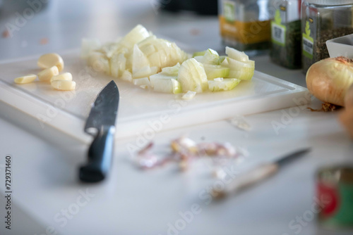 Adult man preparing mince for a lasagne in his modern kitchen photo