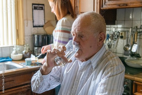 elderley man with assisted living woman organising breakfast photo