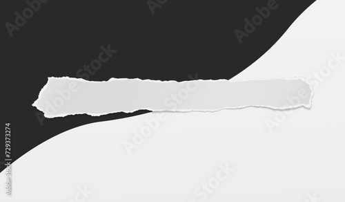 Torn, ripped white paper strip with soft shadow is on black and white background for text or ad.