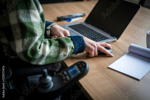 Disabled businessman working on his computer.  photo
