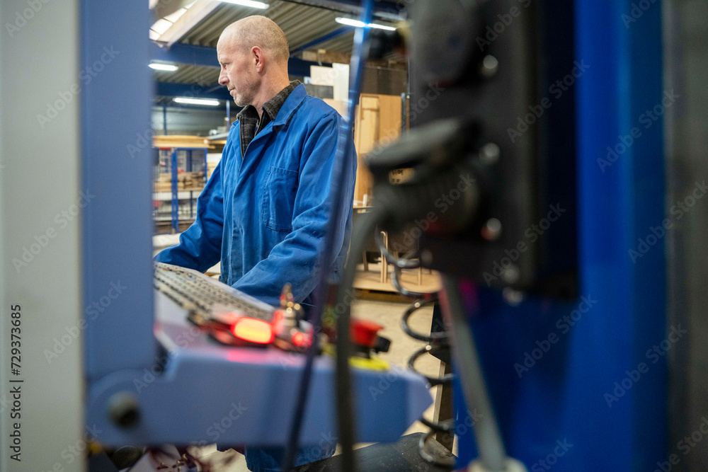 Industrial worker in sheet metal component factory Industrial worker in sheet metal component factory