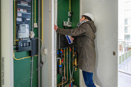 Female Construction manager inspecting electrical installation photo